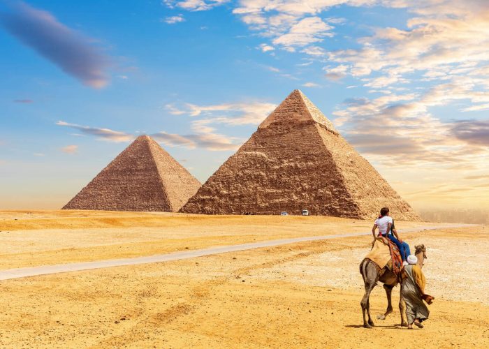 tourists-ride-a-camel-in-front-of-the-pyramids-of-Giza